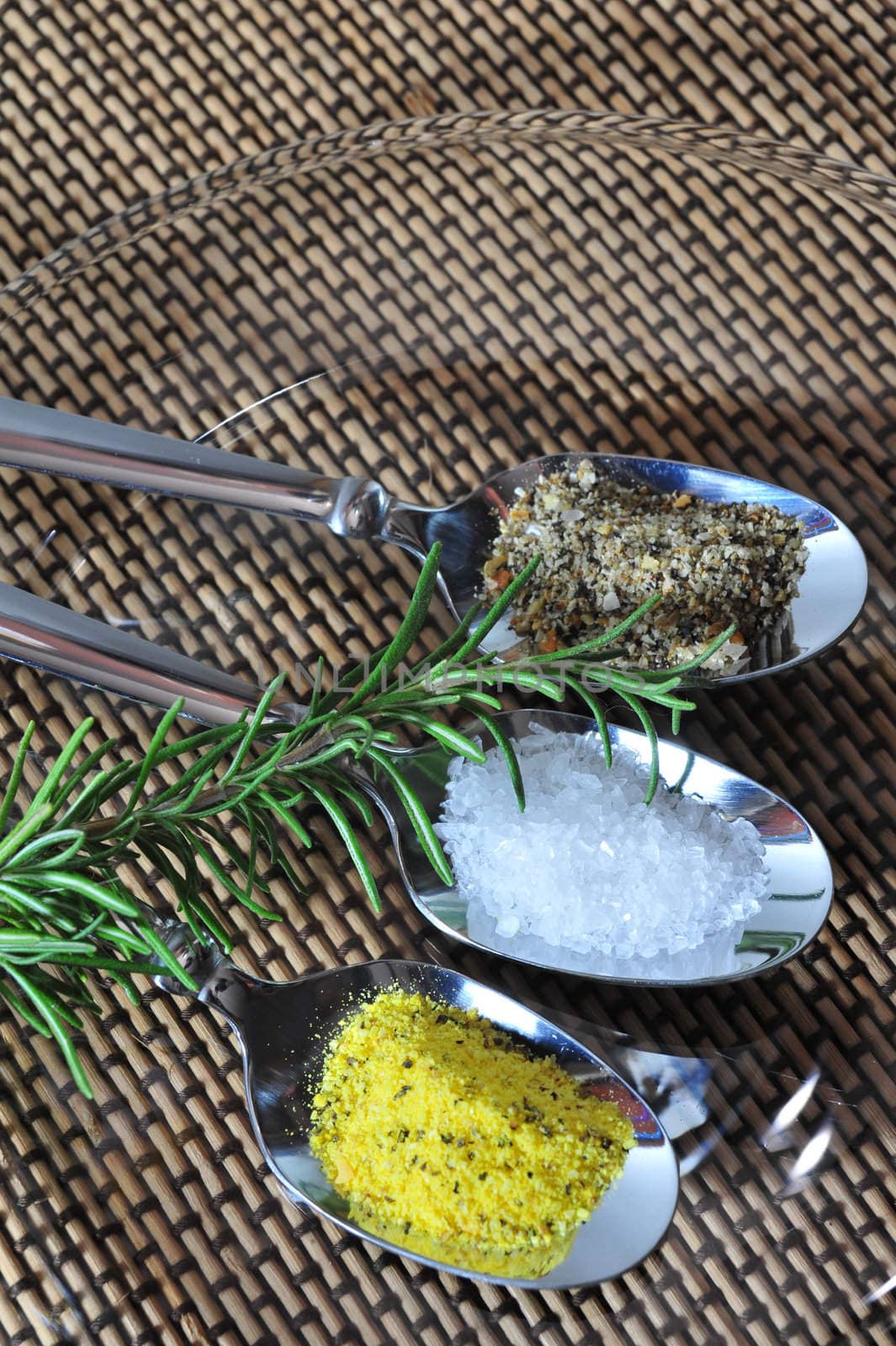 Three different kinds of salt, Mediterranean sea salt, lemon pepper, lime pepper with a sprig of thyme