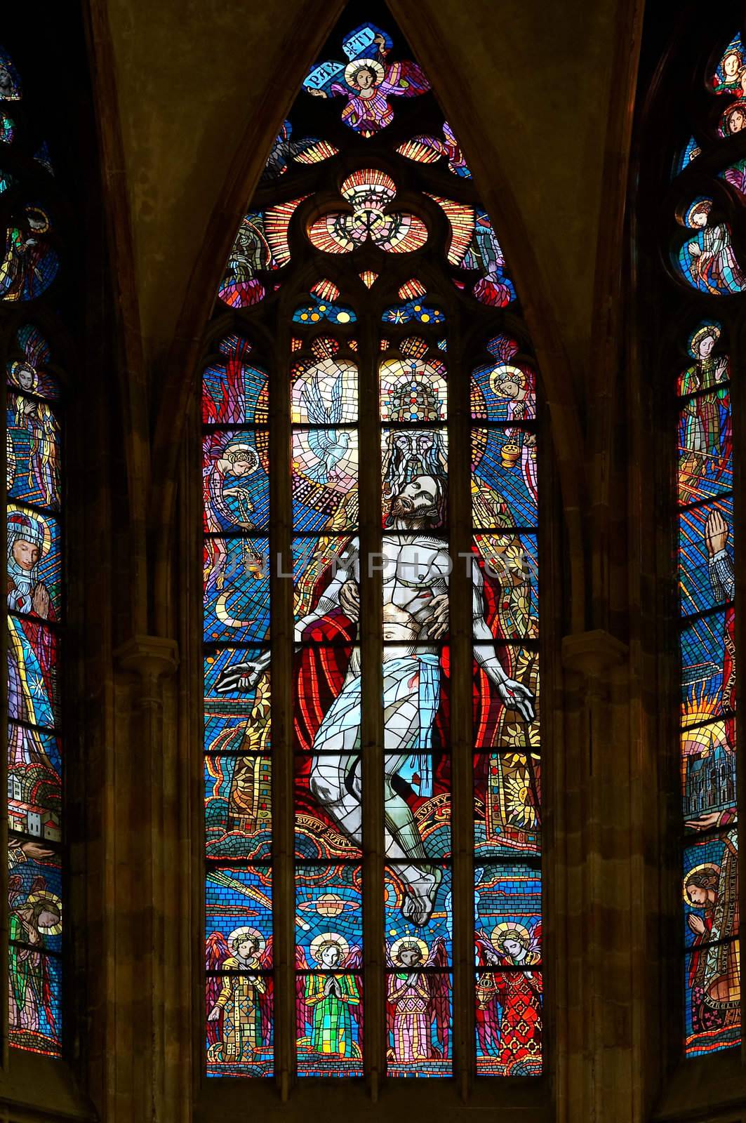 Detail of the color window - bullseye pane - "Holy Trinity".
Design: Max Svabinsky - 1930.
Public national monument - St Vitus cathedral, Prague, Czech republic, Europe.