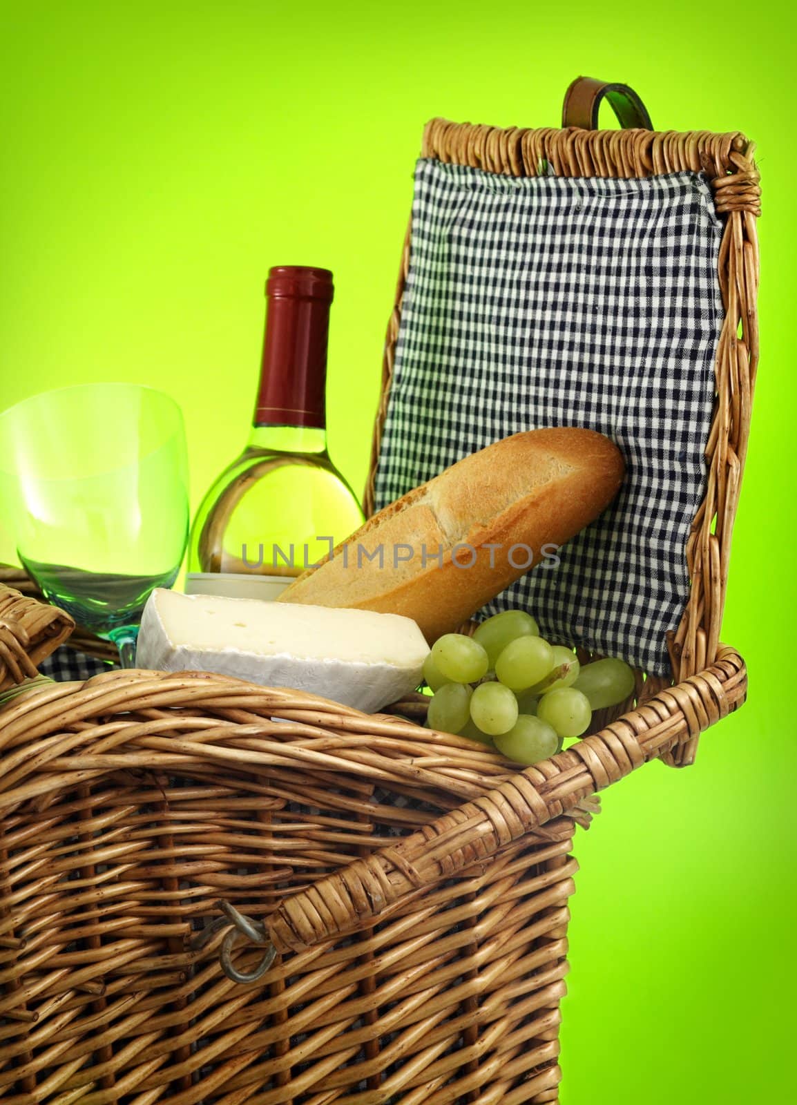 closeup on picnic basket filled with food and wine
