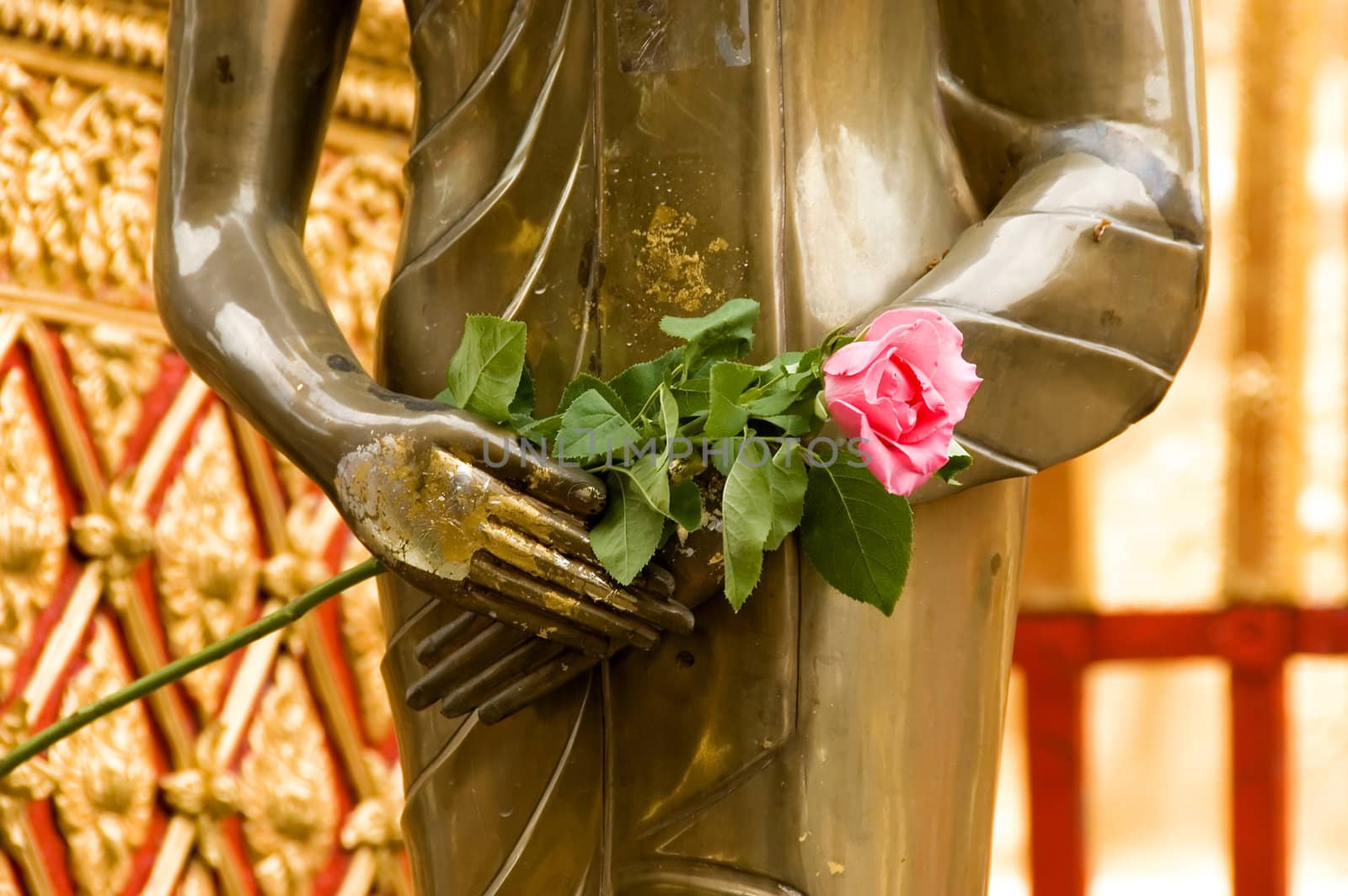 gold statue with rose