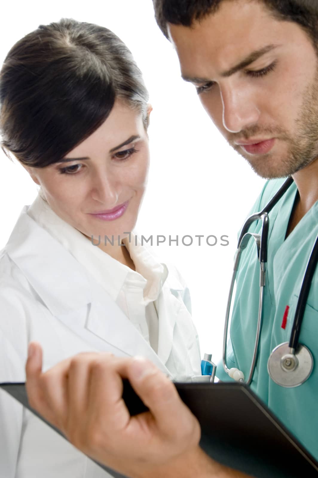 medical professionals looking in writing pad against white background