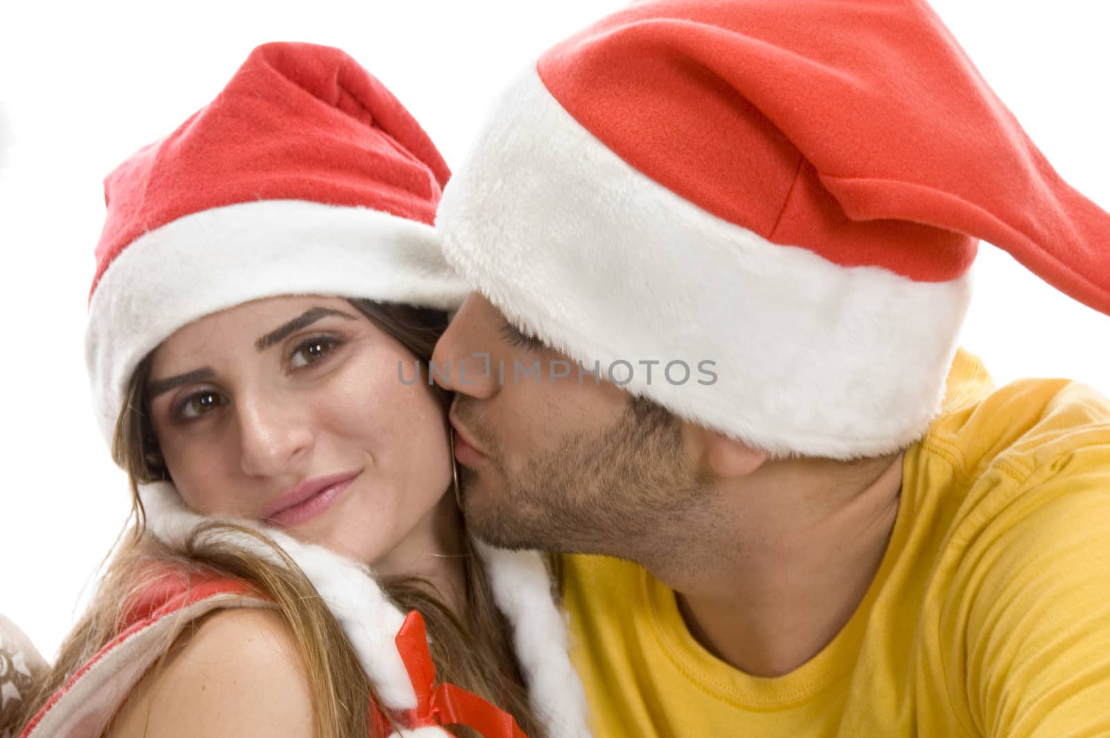 young male kissing female against white background
