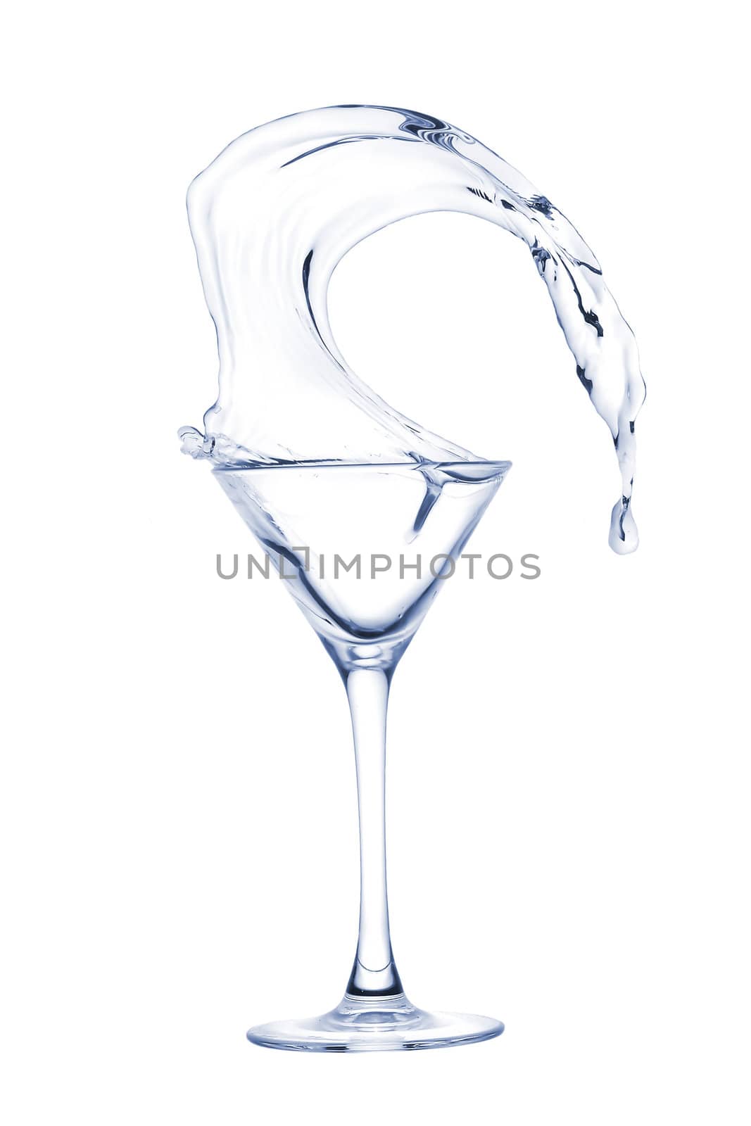 Freakish splashes transparent at its finest from a glass for martini close up.
