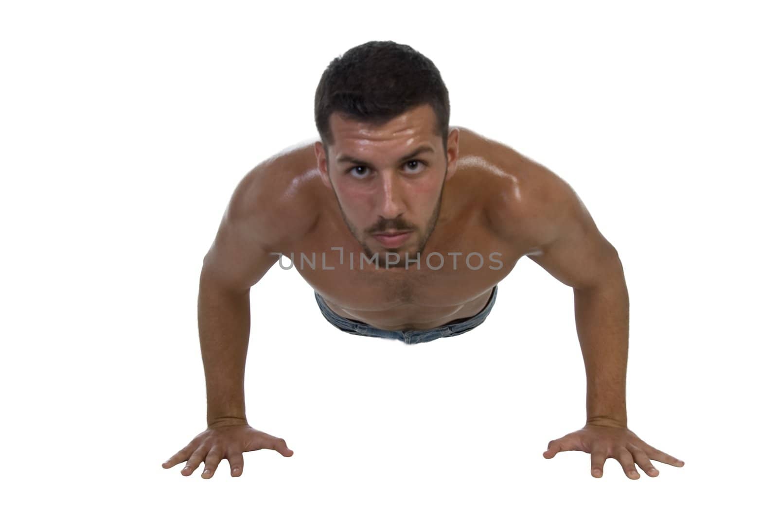 handsome young male exercising on an isolated white background