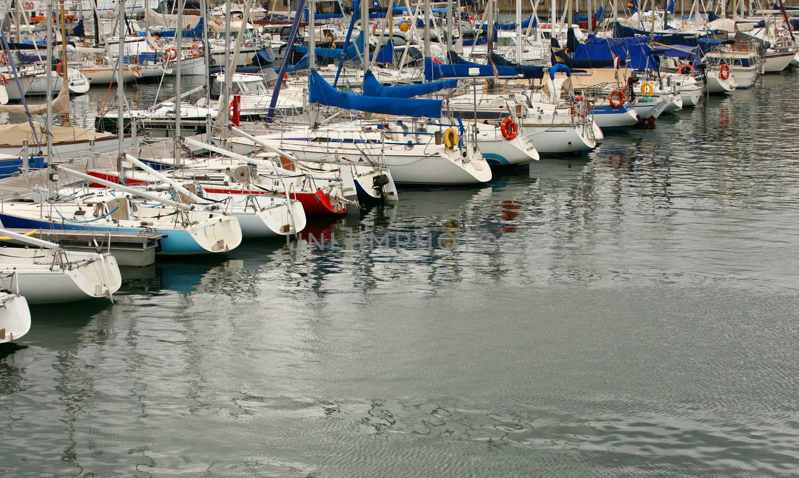 Tall luxury boats and yachts moored in duquesa Port In Spain. Barcelona