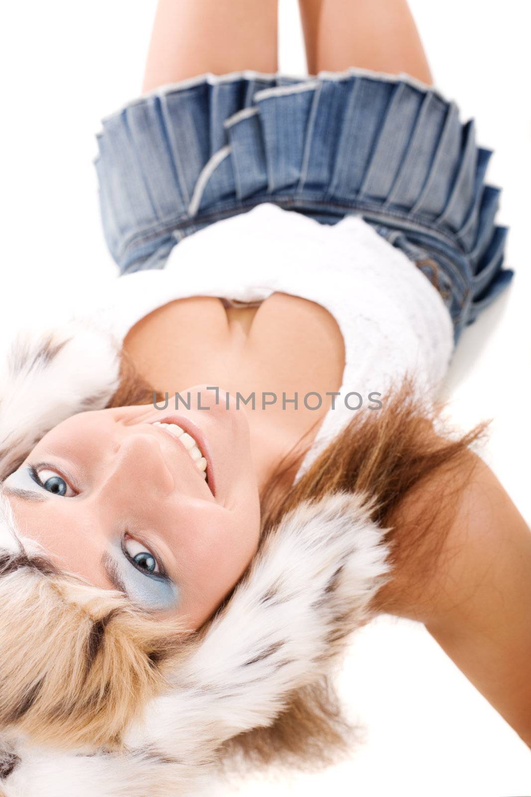 Young woman in denim skirt sitting on isolated white