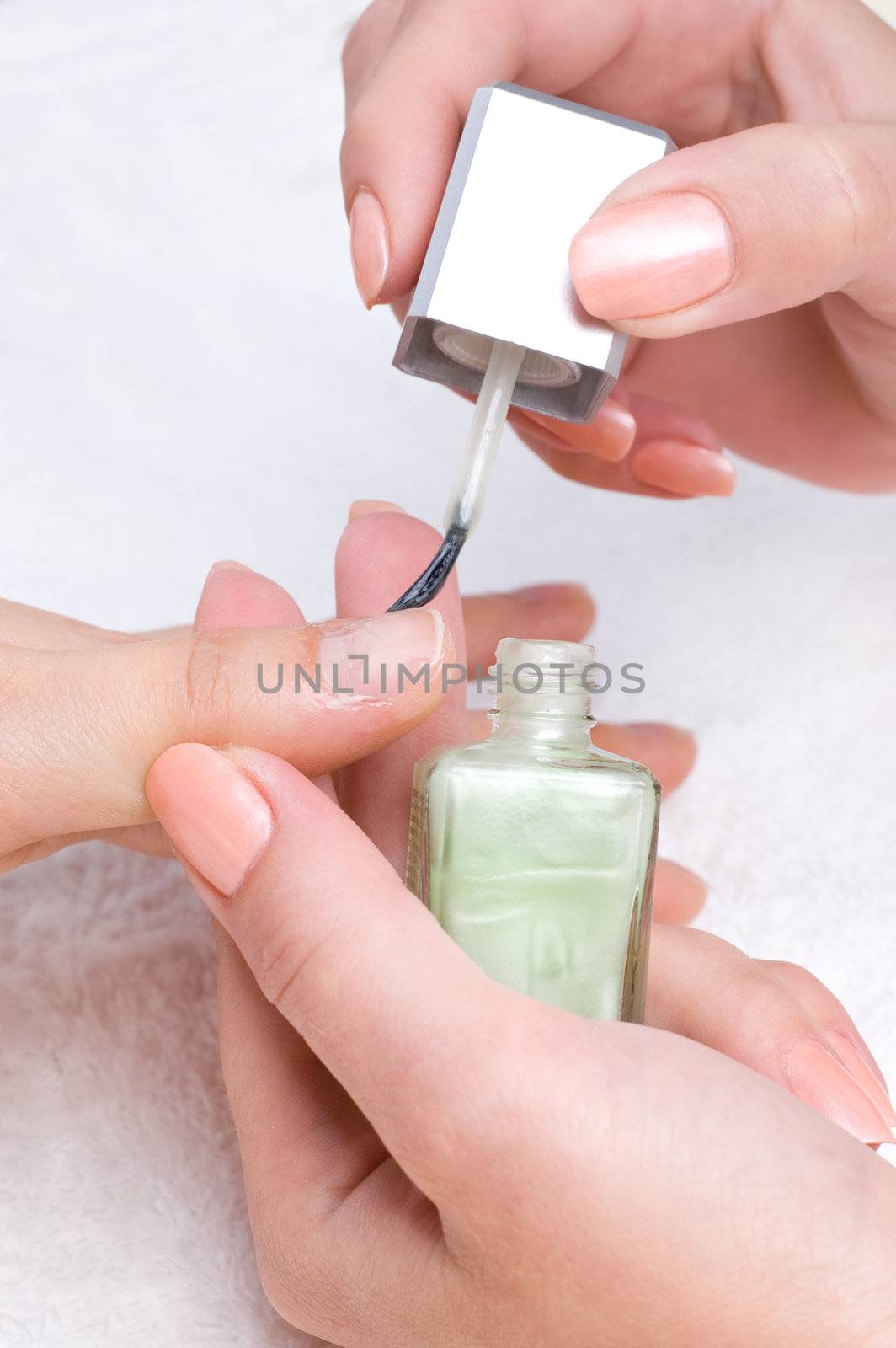 applying manicure: moisturizing the nails and skin around nails