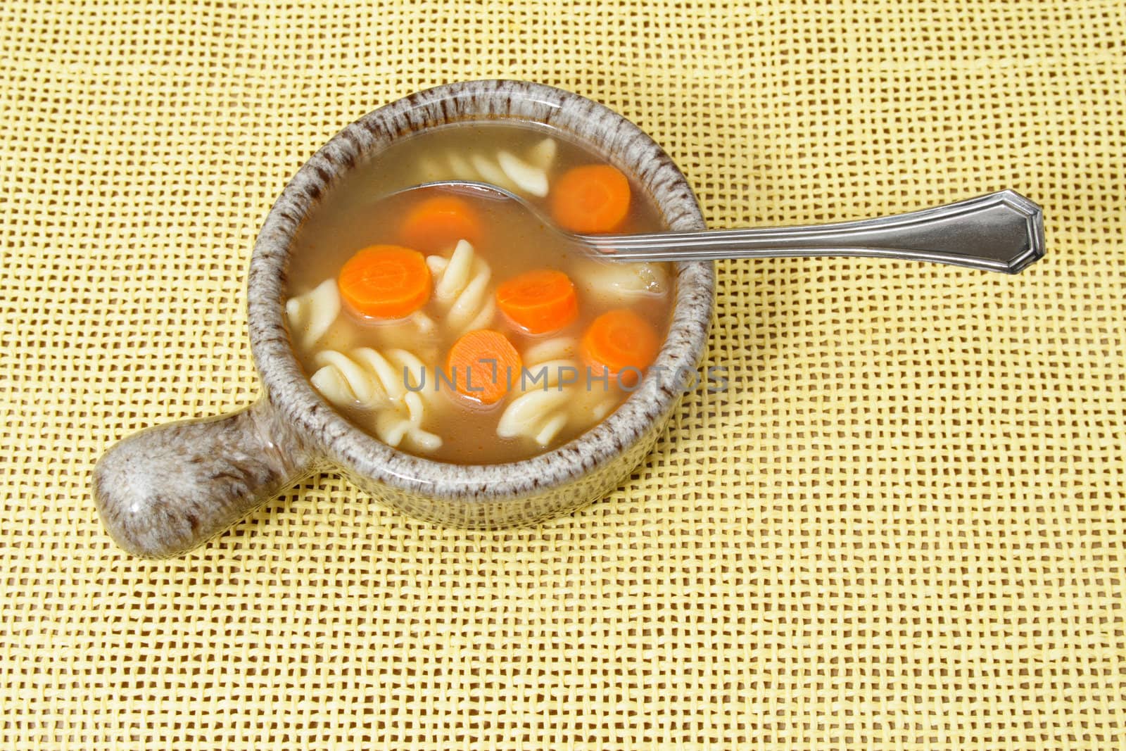 bowl of vegetables soup on yellow tablecloth