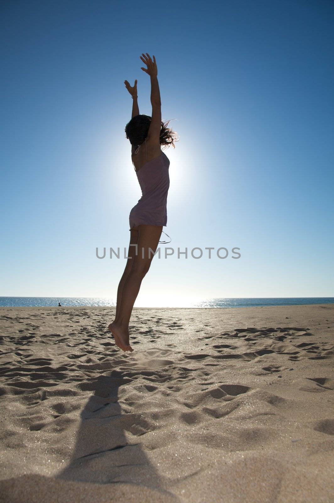 woman against the sun light at a spanish beach