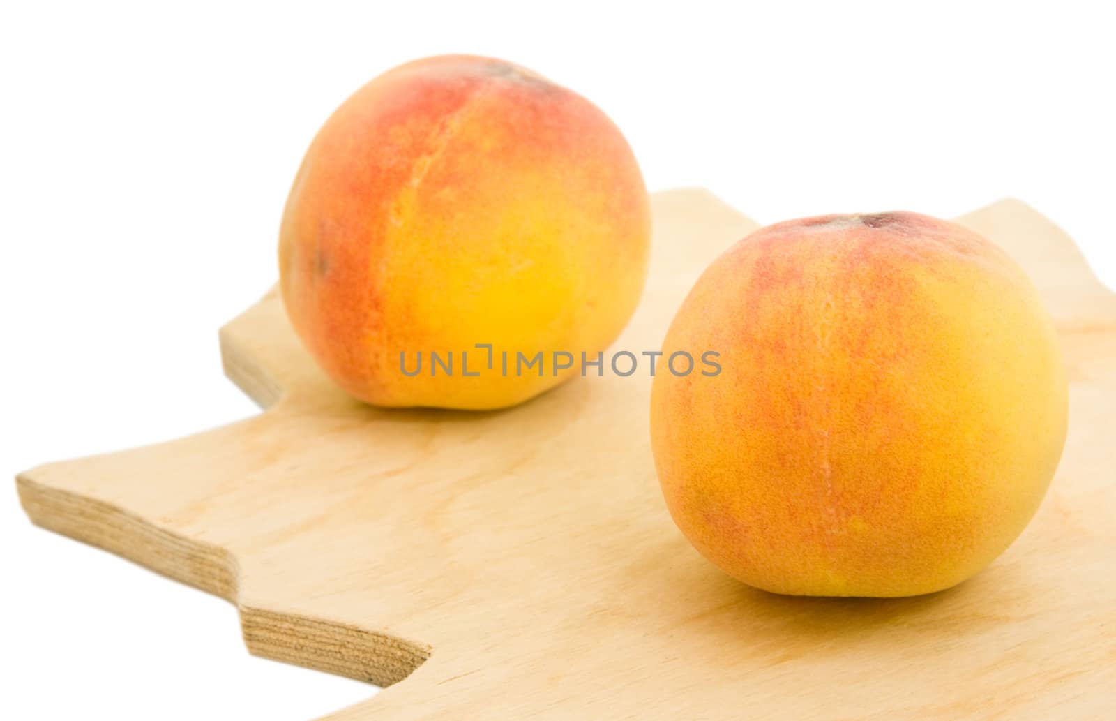 Two appetizing peaches isolated over white