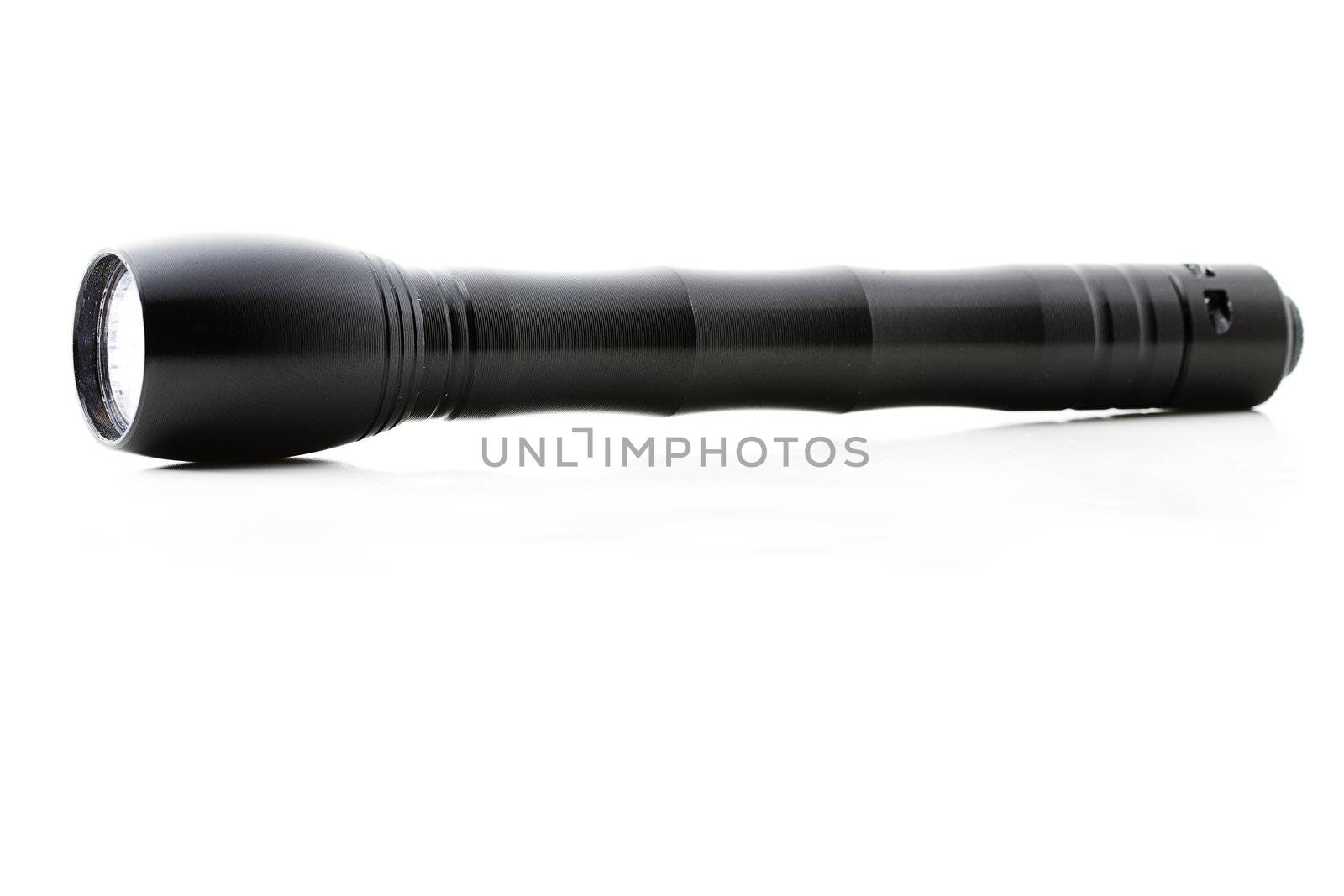 one flashlight from the side on white background
