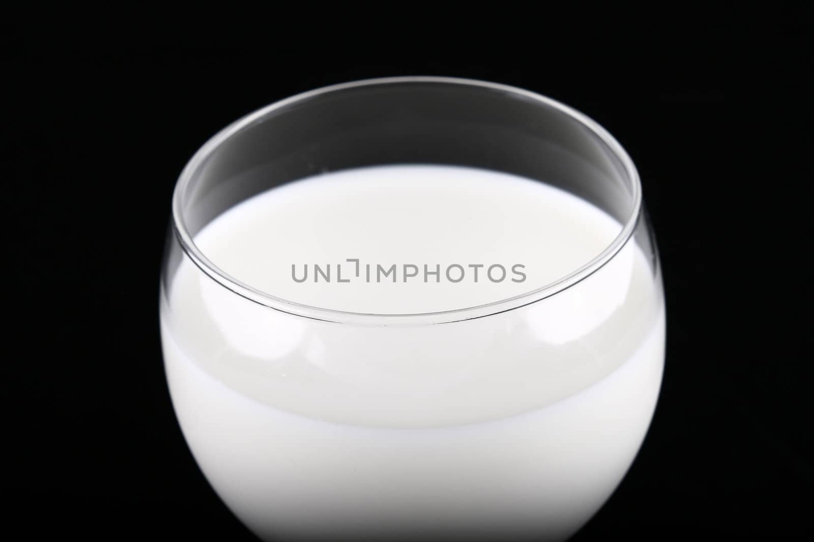 glass of milk isolated on black background