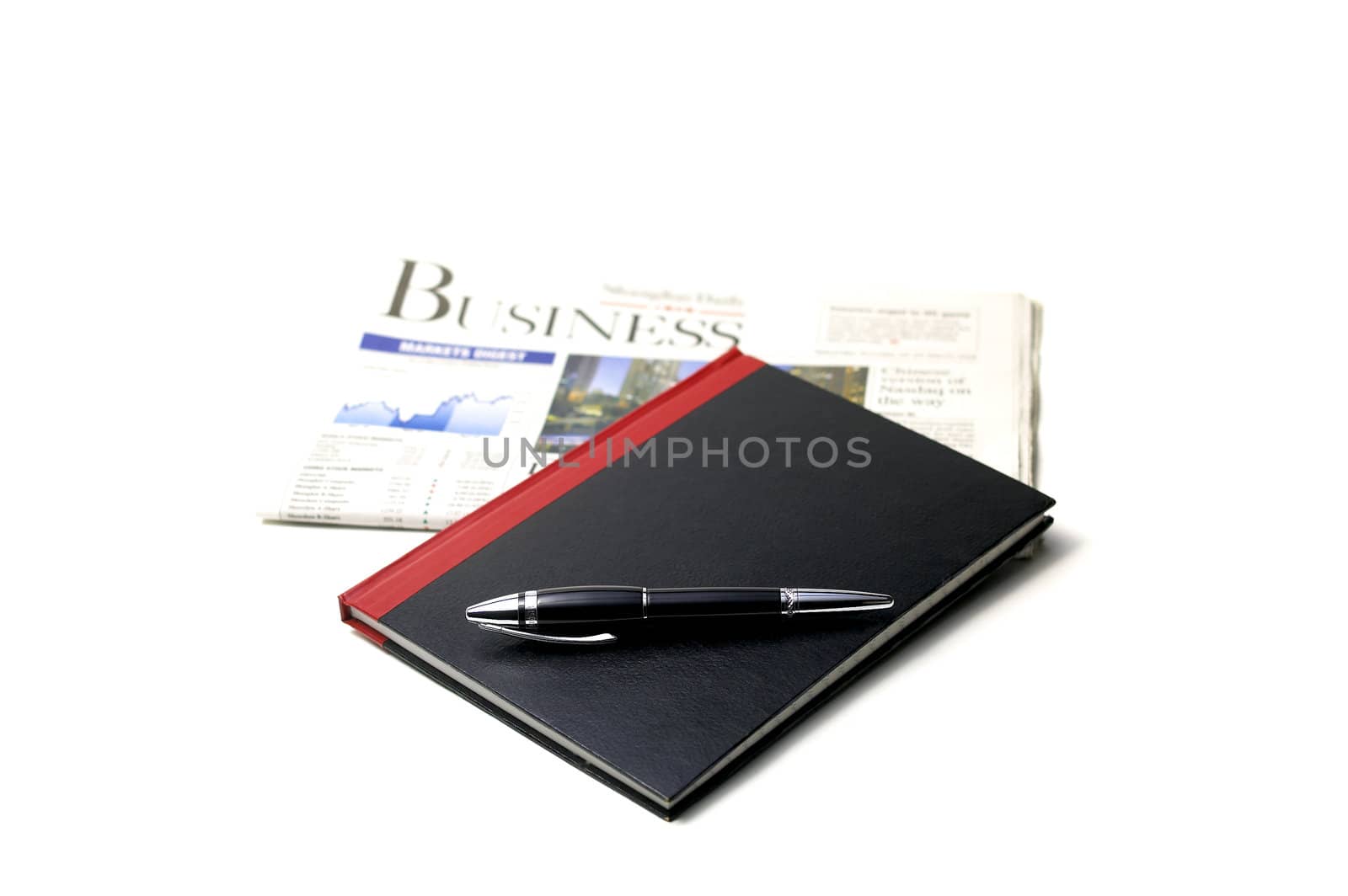 newspaper, pen and notebook on white background