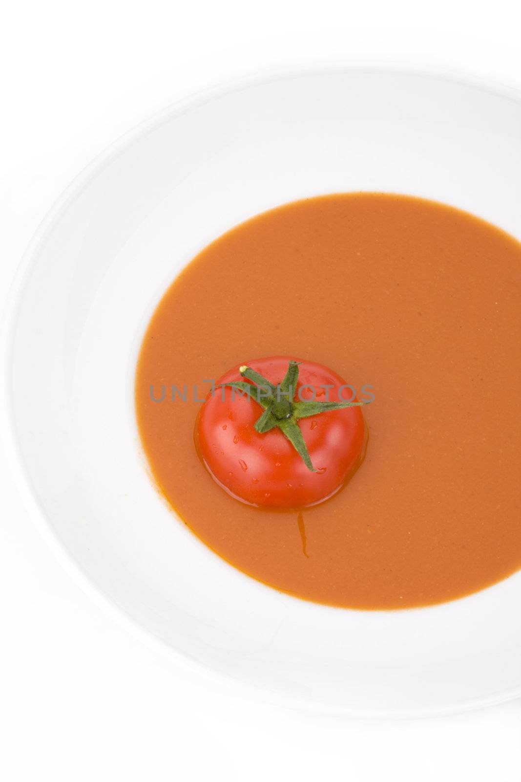 home made tomato soup in a white bowl by bernjuer