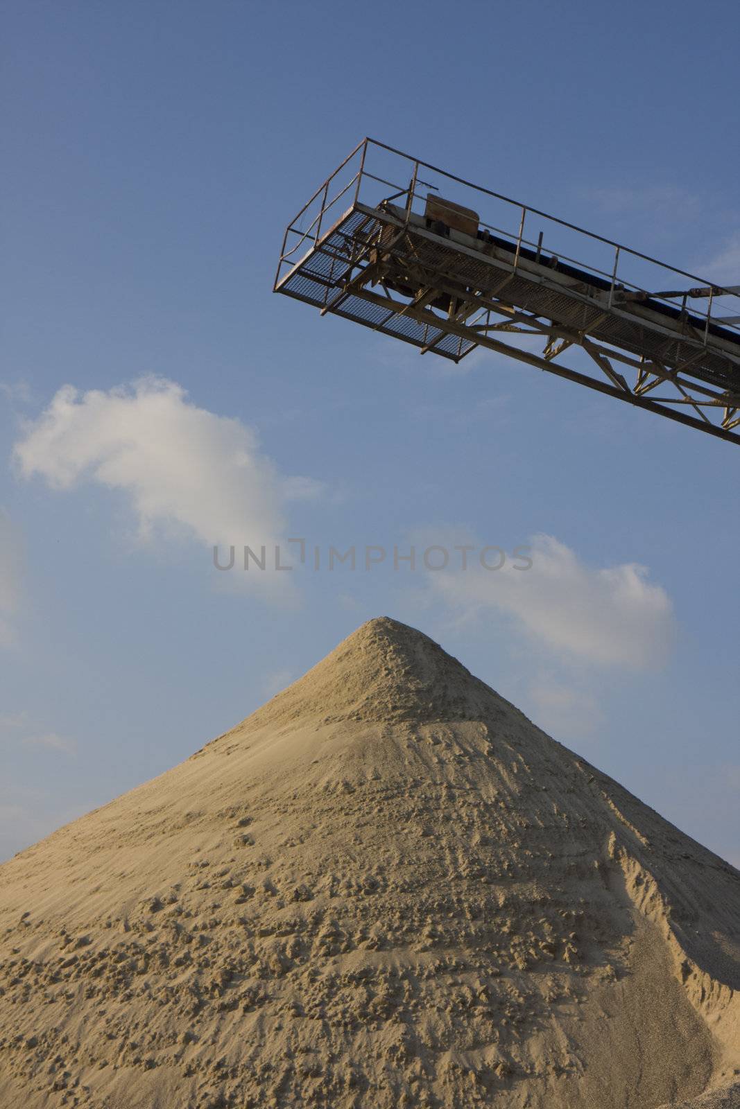 belt conveyor and a heap of gravel