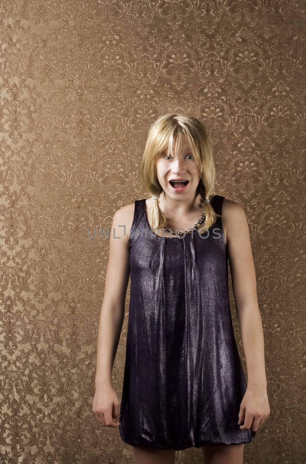 Pretty young girl screaming in a party dress