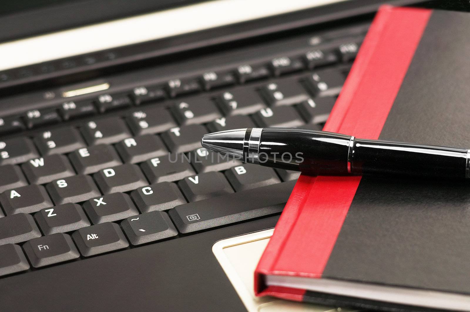 laptop keyboard and notebook with fountain pen