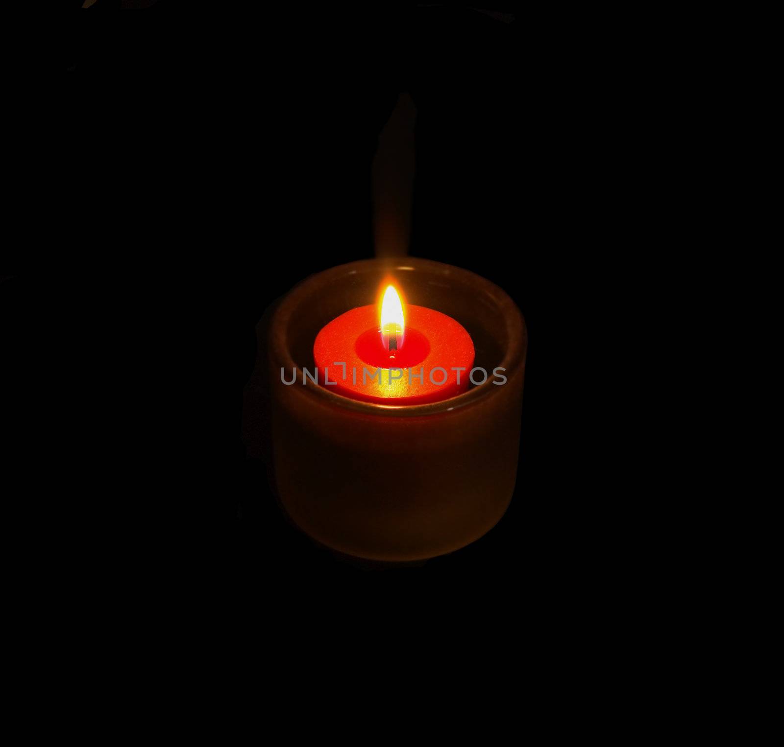 candle glowing on the dark