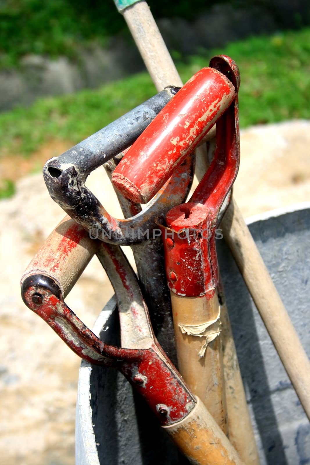 Handles of construction tools put aside during break time.