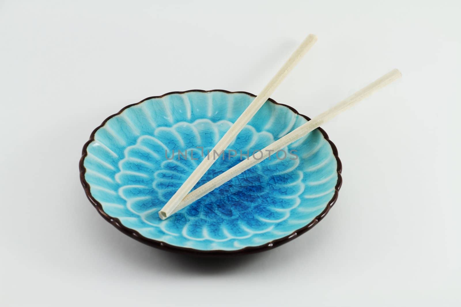 Chopsticks on Blue Plate