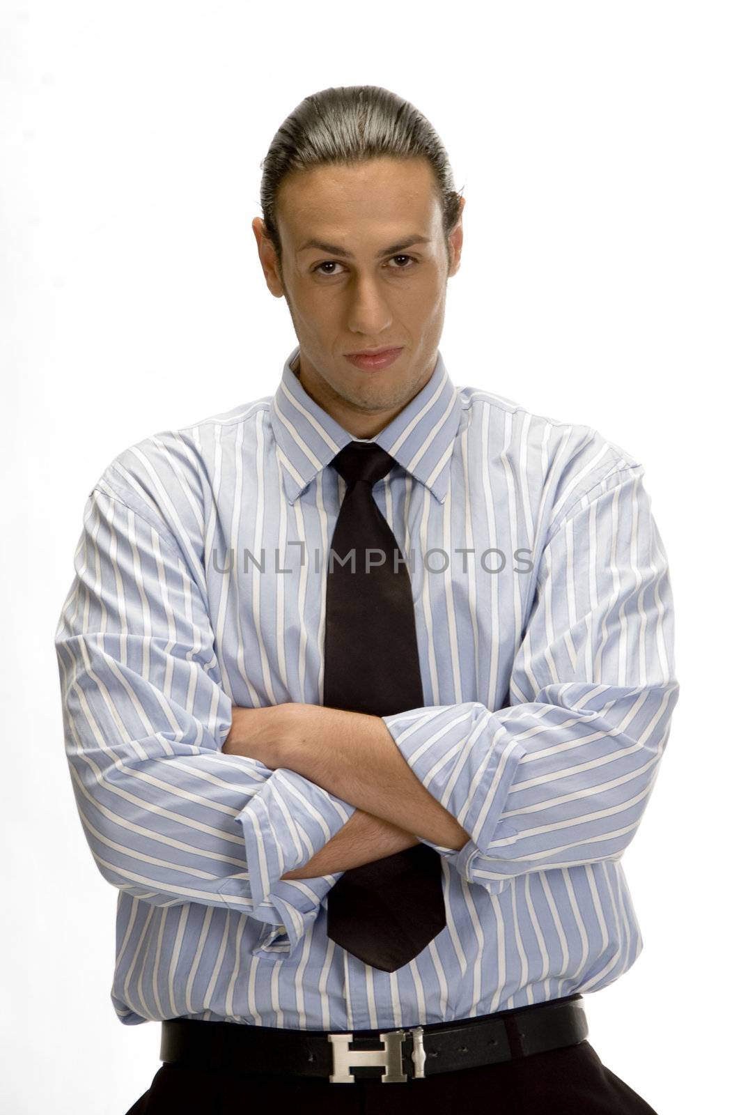 portrait of young handsome businessman with arms crossed