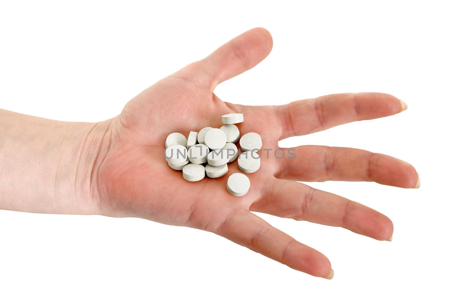 Handful of tablets on a female hand
