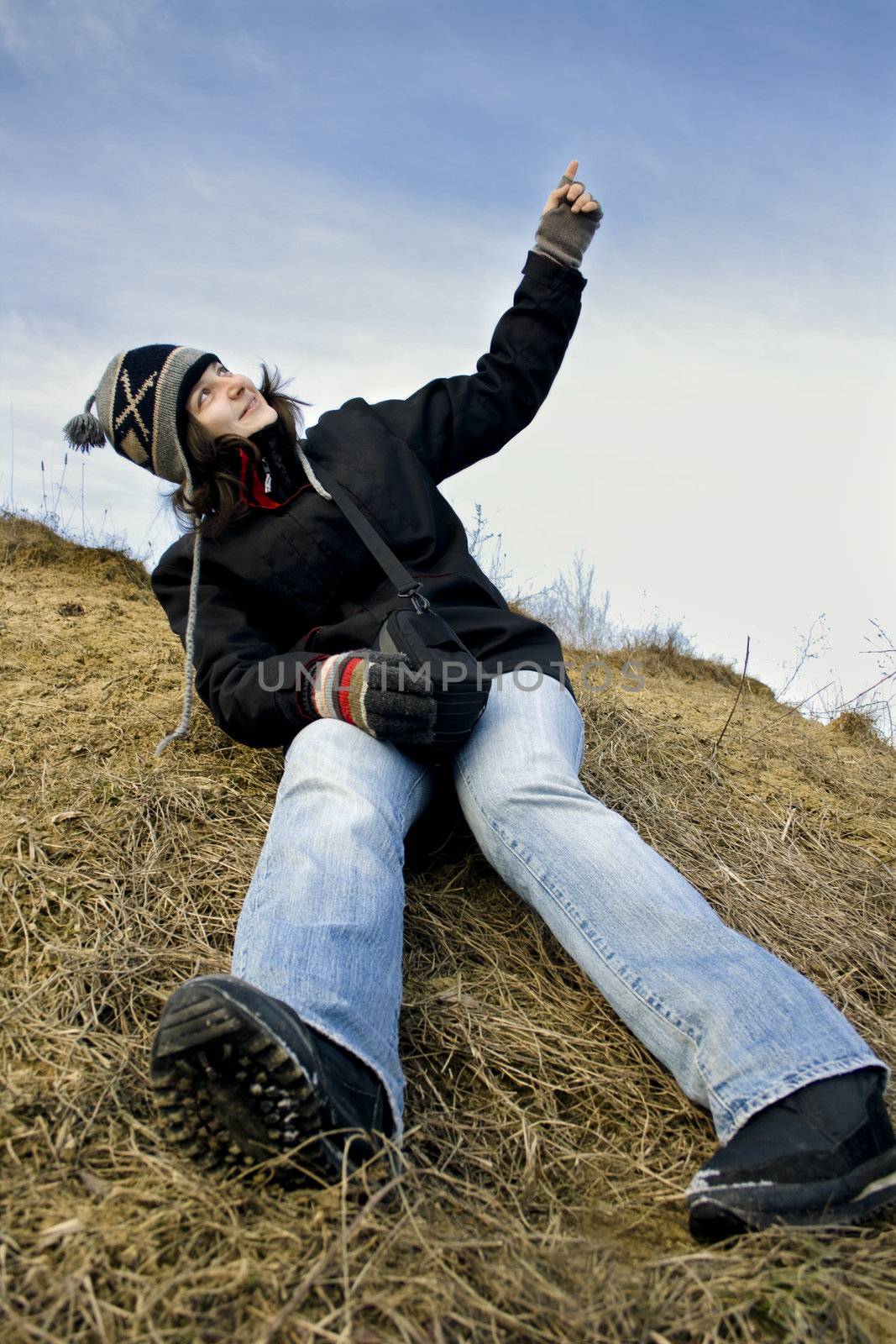 Young girl pointing to the sky.