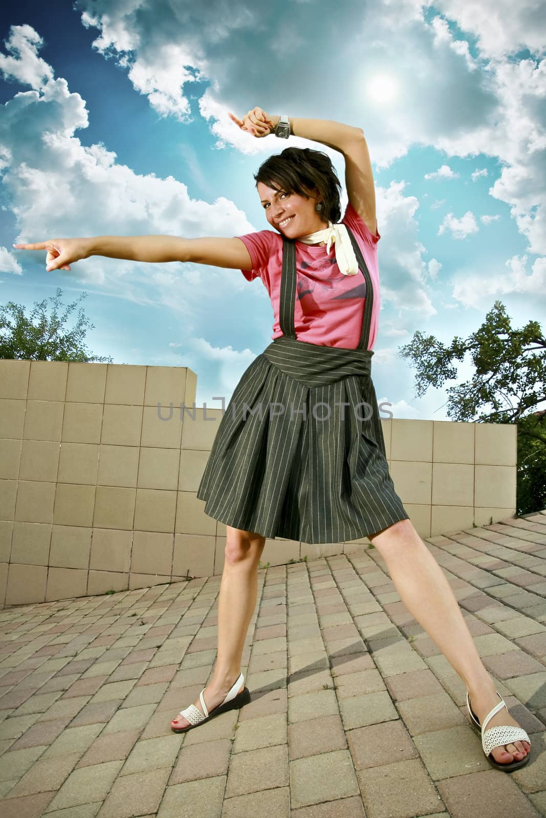 Girl in urban environment, showing directions.