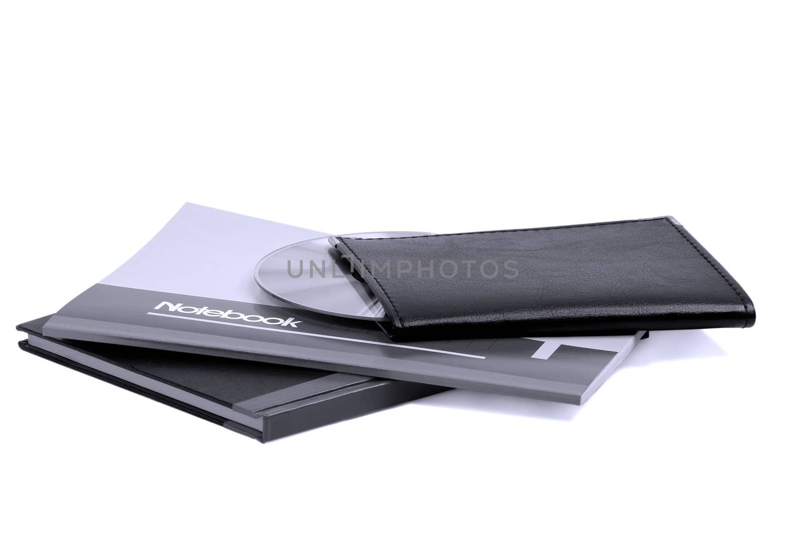 assorted notebooks with a cd flat piled on white background,blue filter