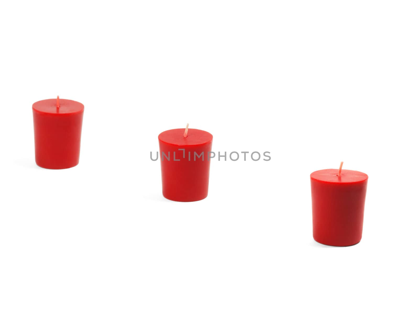 three red candles isolated on white background