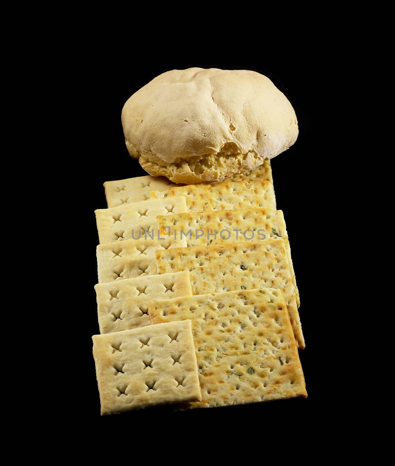 fresh bread and crackers on black background