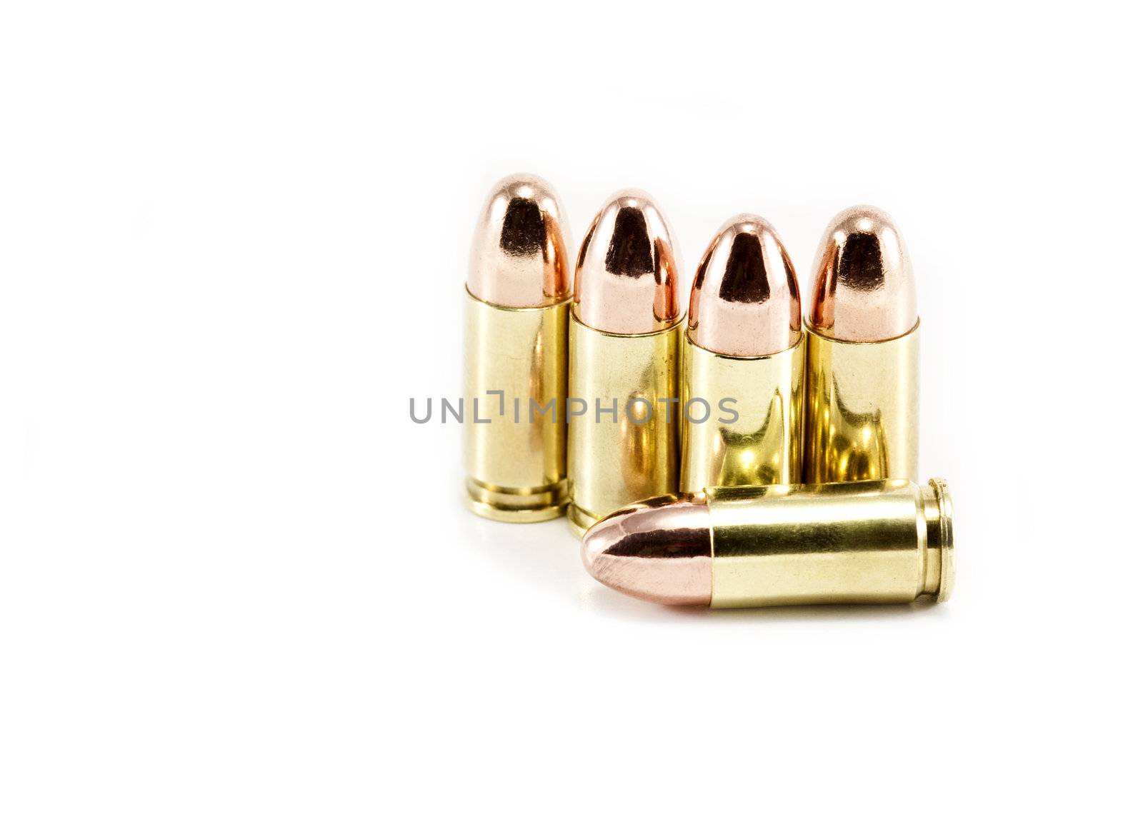 Five 9mm bullets isolated on white by ChrisAlleaume