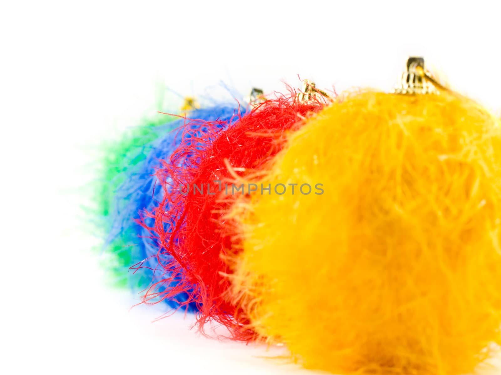 Fluffy christmas baubles on white background, focus on red bauble