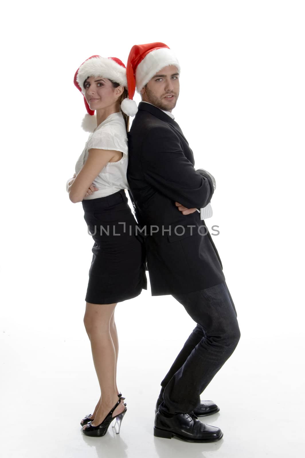 smiling couple posing with santa cap on an isolated white background