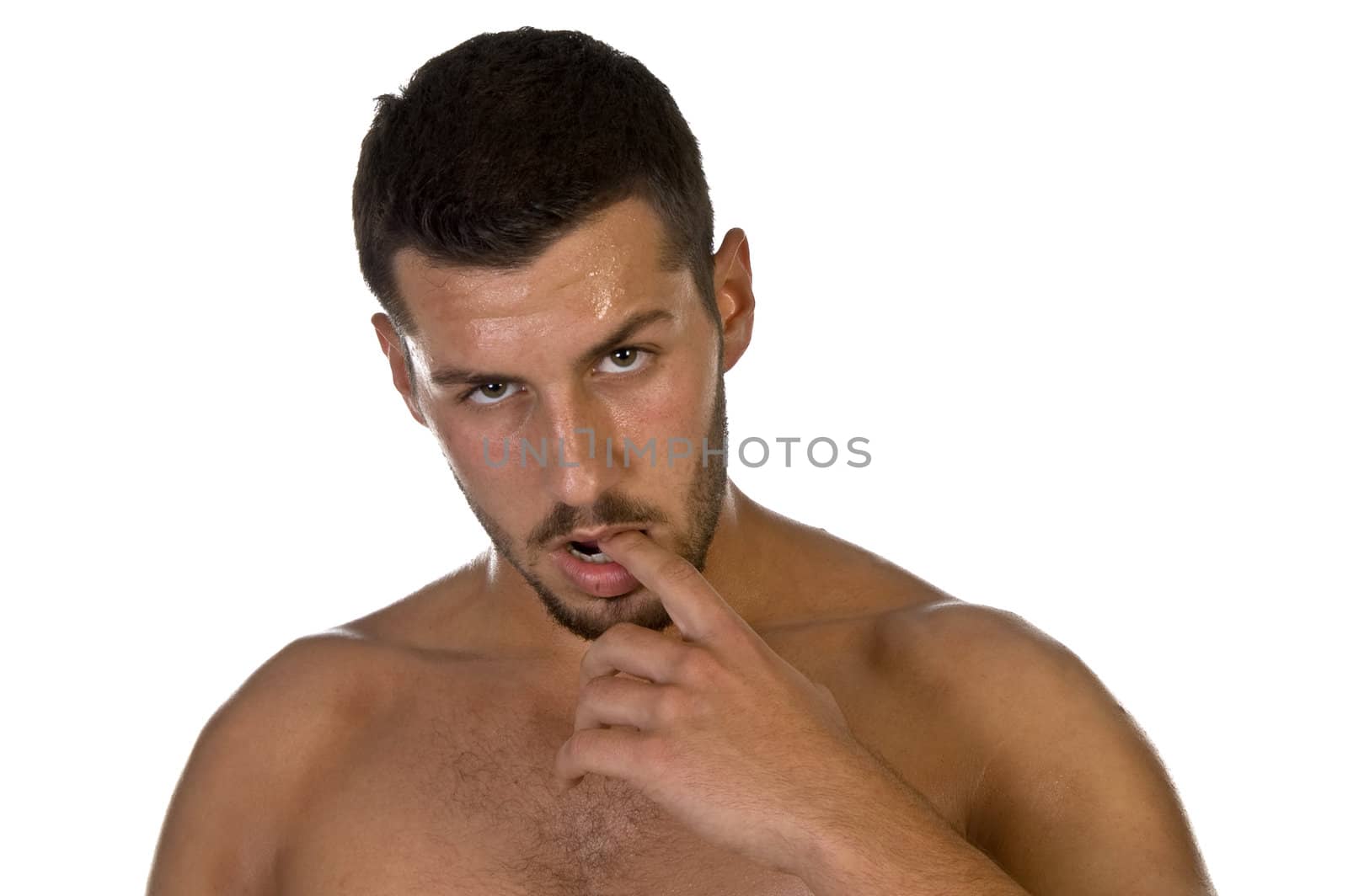 young male looking with finger in his mouth on an isolated background