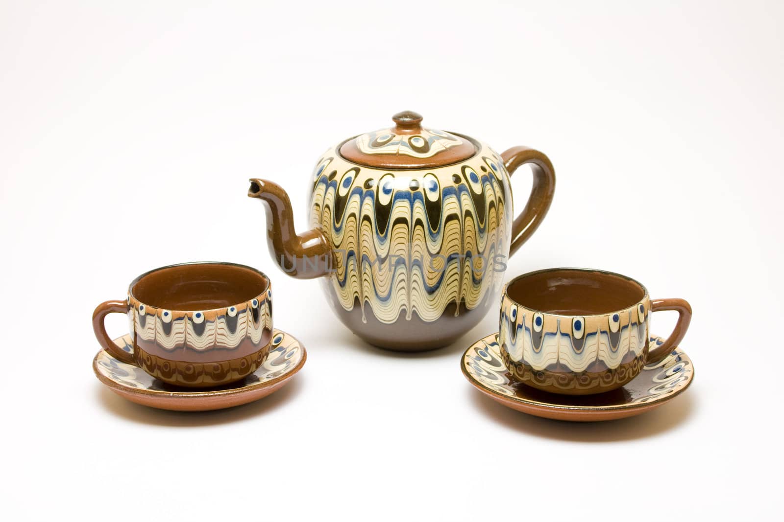 Ancient kettle and two cups isolated on white