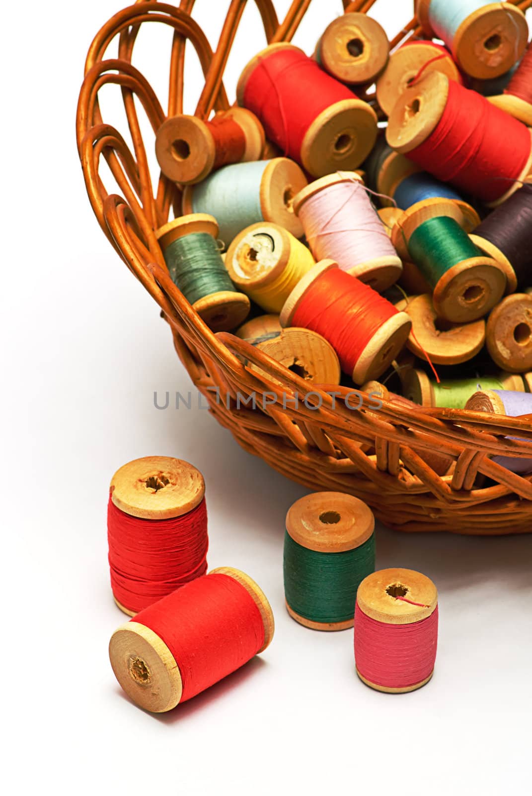 
thread spool and  bobbin
 in wooden basket