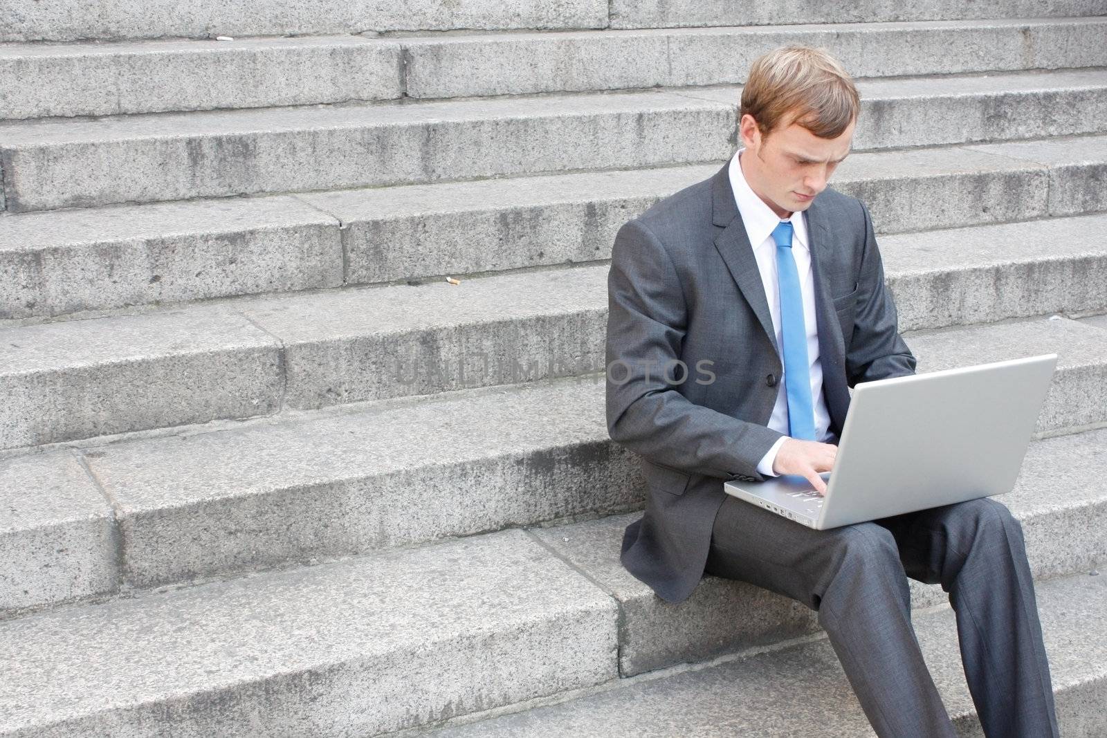 Business man sitting on stairs outdoor