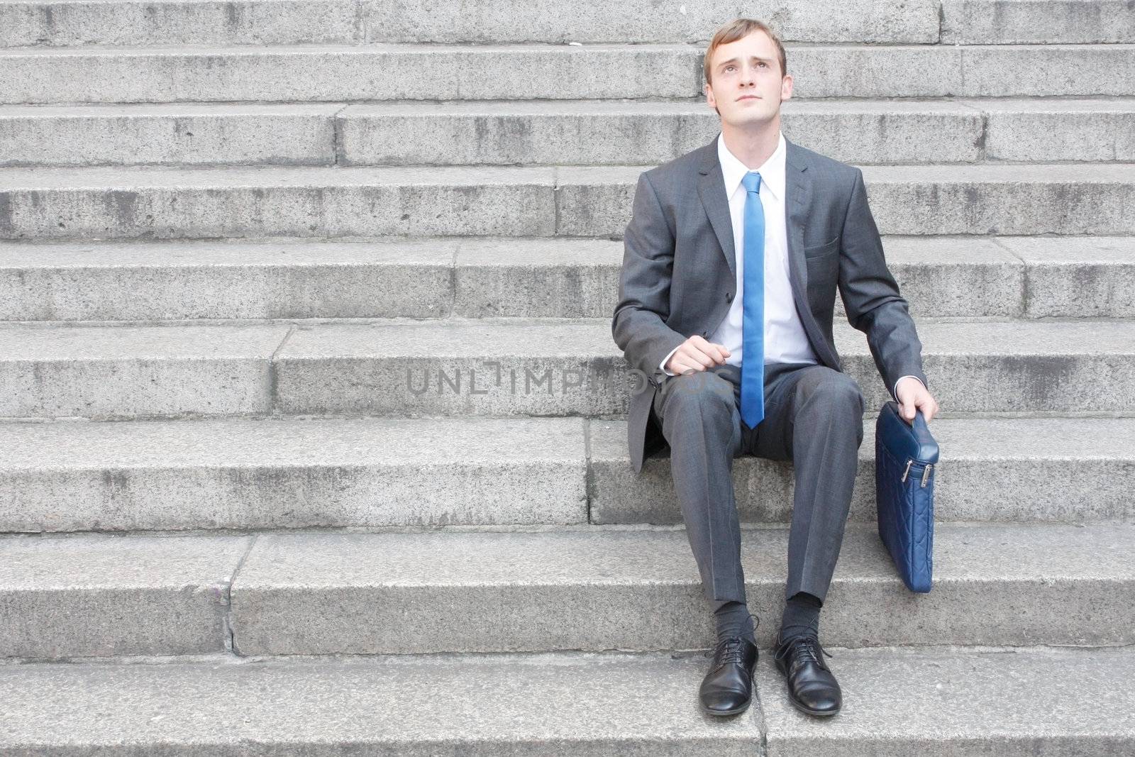 Business man sitting on stairs outdoor