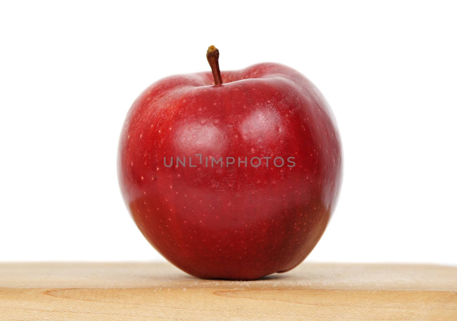 red apple on wood plank by lanalanglois