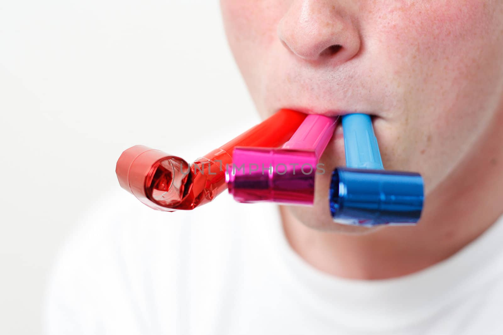 A person playing with party blowers