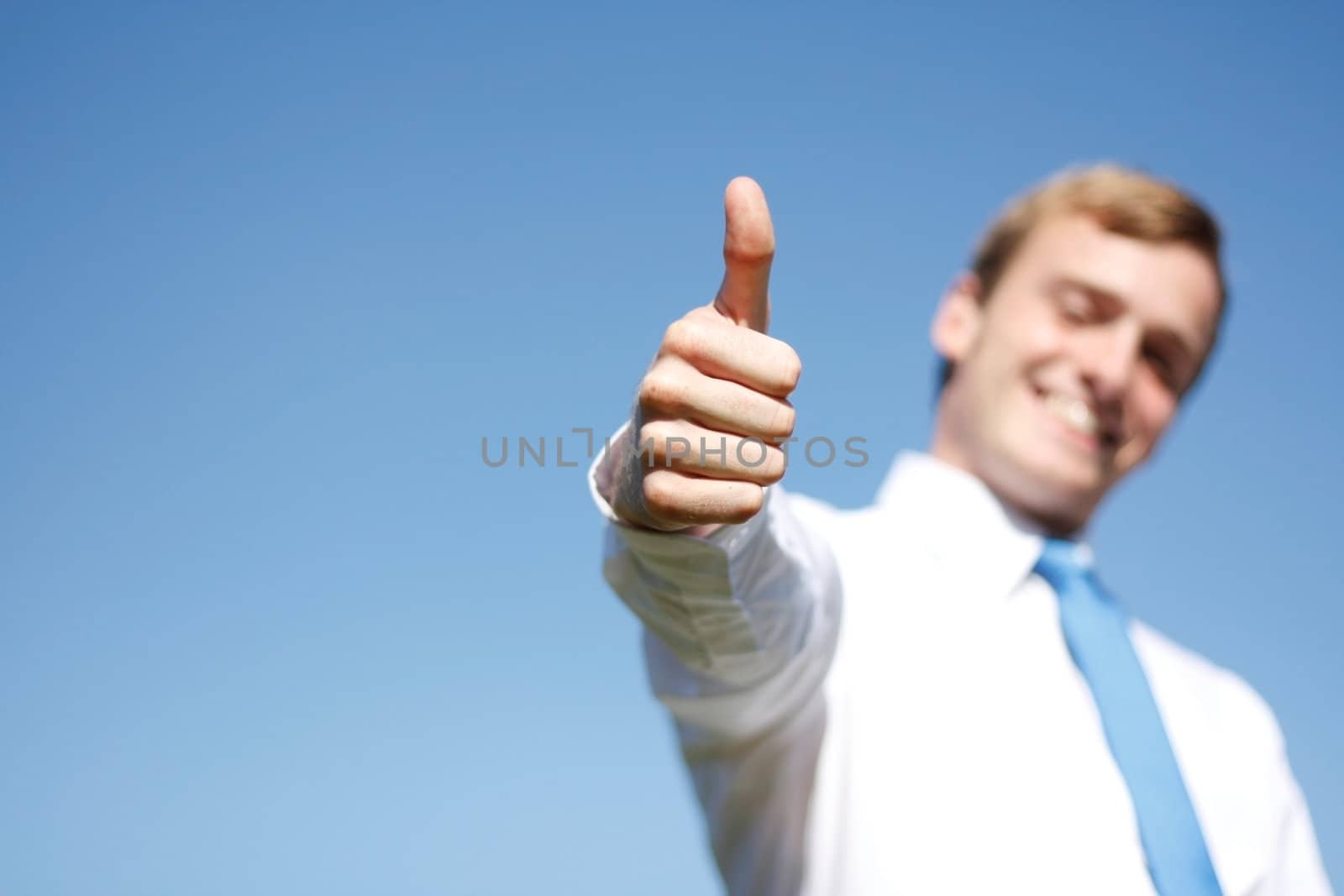 A business man giving thumbs up