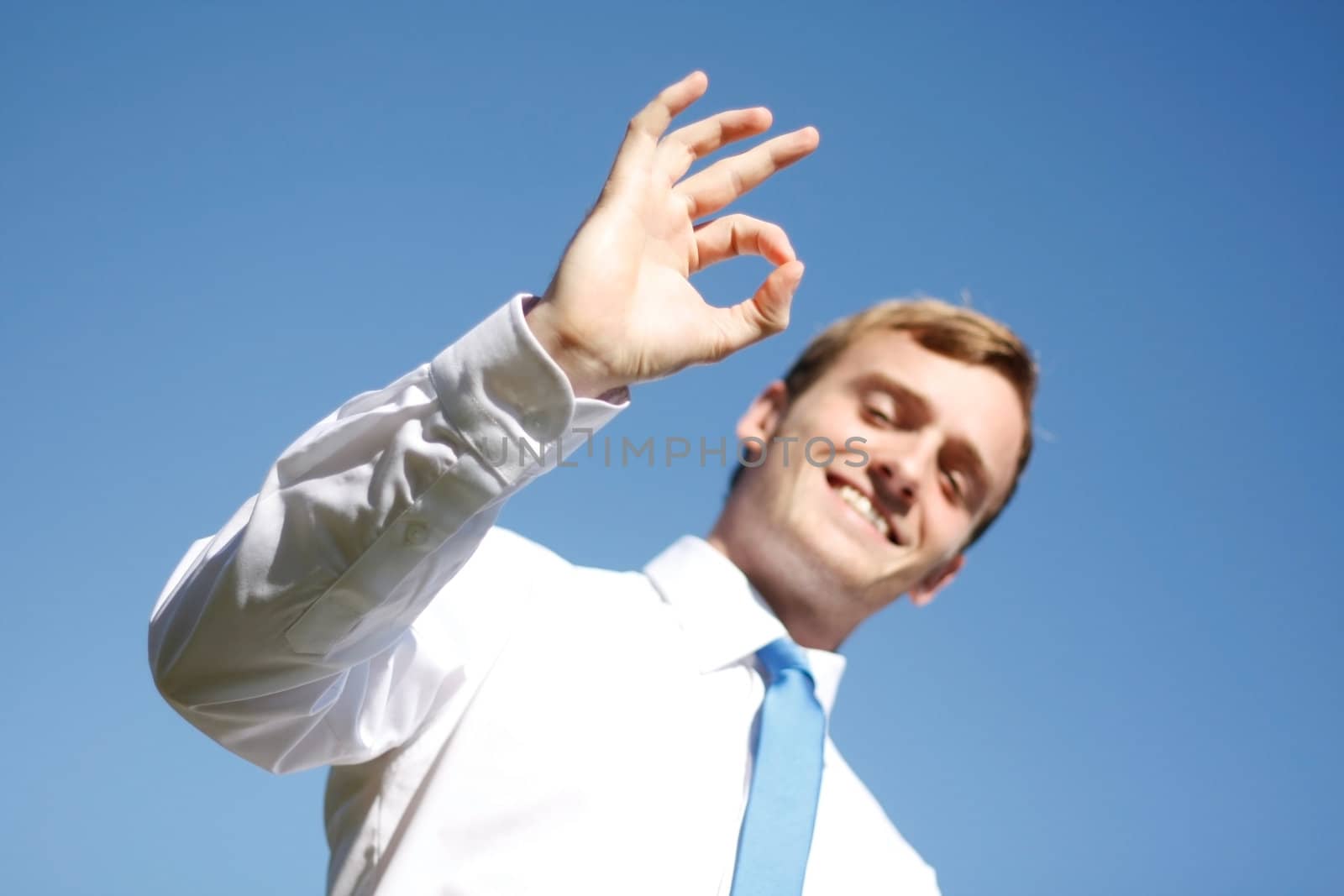 A business man displaying OK signs