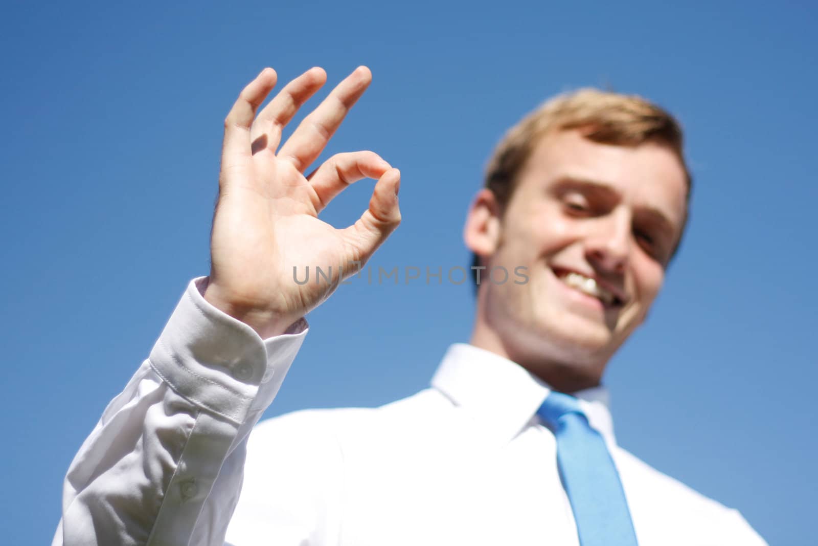 A business man displaying OK signs