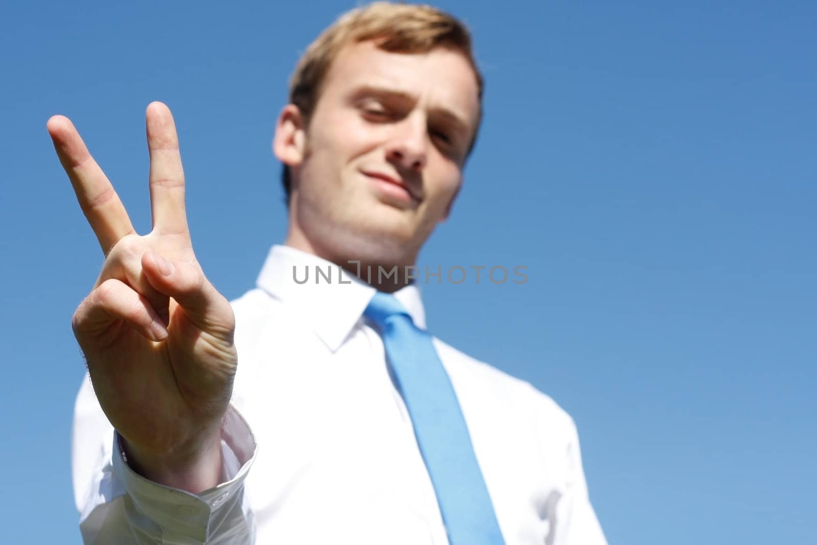 A business man showing the V sign