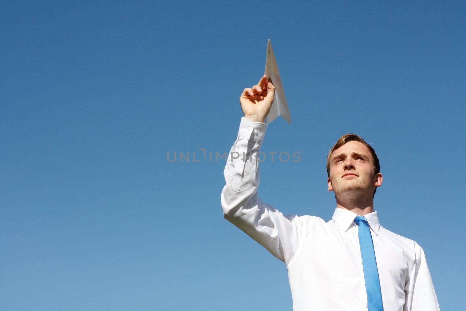 A business man throwing a paper plane