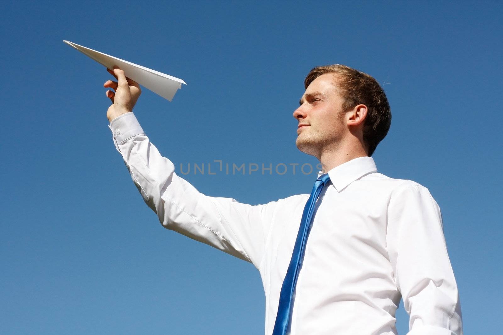 A business man throwing a paper plane