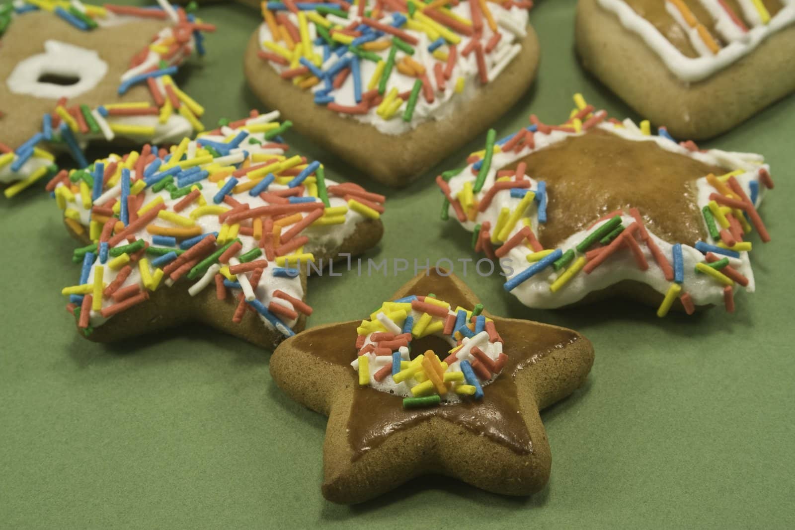 Decorated gingerbread cookies on green paper