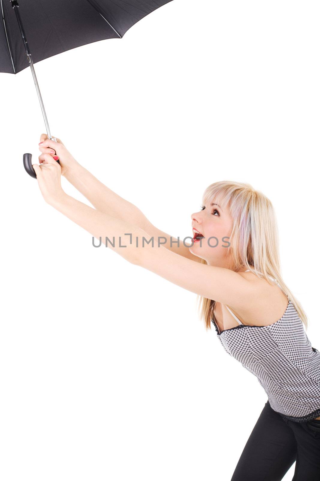 Young woman catching umbrella in the wind