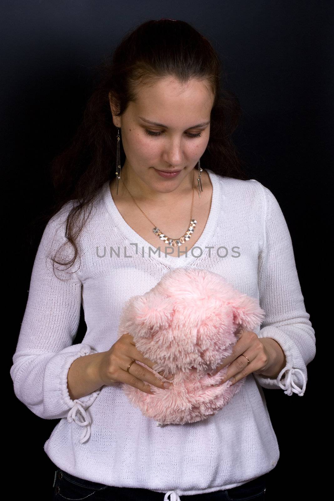 Female looking into plush toy in hands